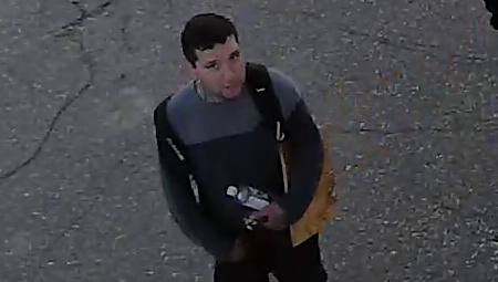 Photo of the suspect wearing a long sleeved shirt, black pants and carrying a backpack