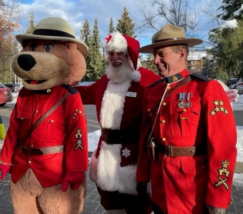 Santa, Safety Bear, and member in red serge