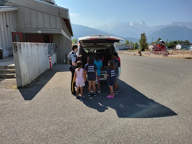 Cadets looking into a police vehicle 