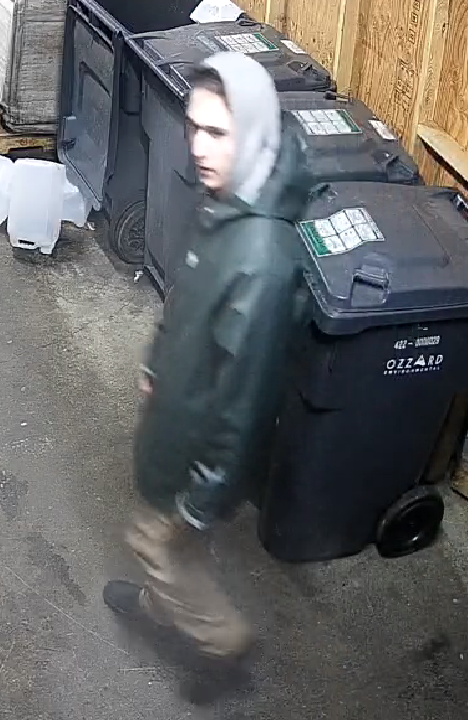 suspect wearing a dark jacket and grey hoodie